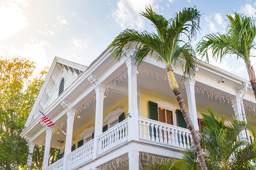Key West, Florida, USA - December 30, 2020: General landscape view of traditional old architecture in Key West on a sunny winter day before New Year's Eve. The city is completed empty during the Corona Virus Breakdown Illness Pandemic. \n\nBeautiful picture as street photography style.