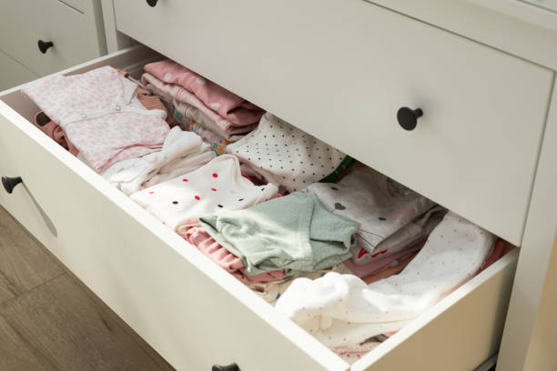 istock Cute newborn clothes in drawer 1302035532