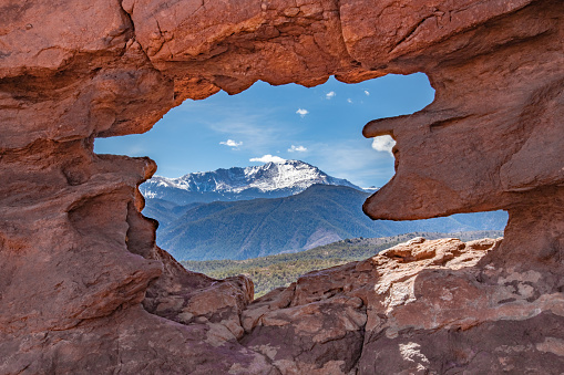 Pikes Peak through hole red sandstone rocks of Garden of the Gods,
