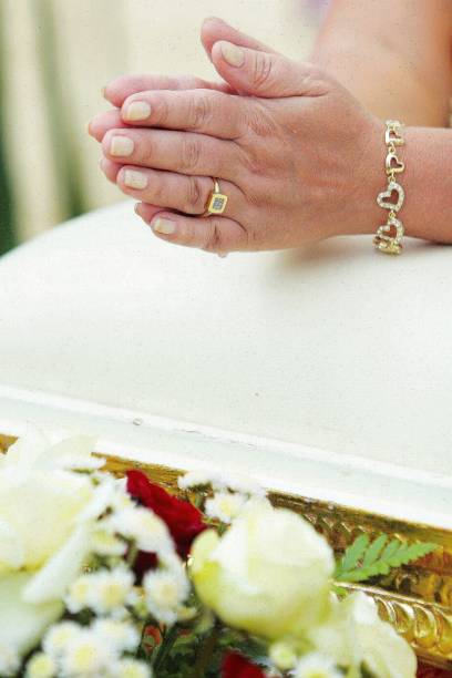 istock hands of a praying woman on a white table 1302042100