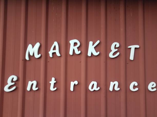 istock white market entrance sign on red wall 1302042972