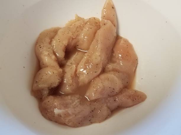 istock raw seasoned chicken with pepper in white bowl 1302042980