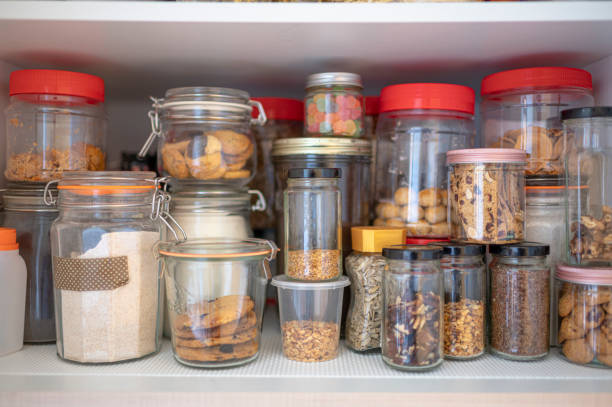 cabinet closet full of bottle of dried food, preserved food, biscuits , nuts, snack, candy, raw food, flour, cereal cabinet closet full of bottle of dried food, preserved food, biscuits , nuts, snack, candy, raw food, flour, cereal airtight photos stock pictures, royalty-free photos & images