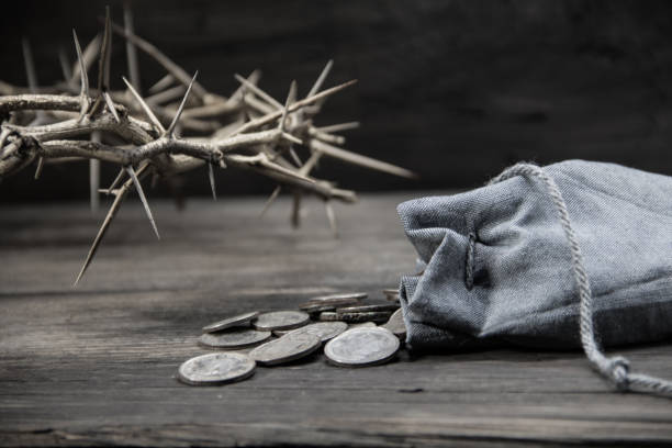 betrayal concept. the thirty silver coins of Judas sack with the thirty silver coins biblical symbol of the betrayal of judas judas stock pictures, royalty-free photos & images