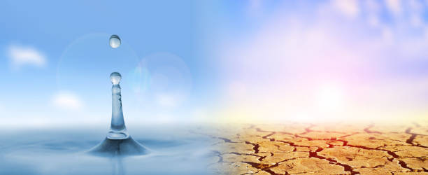 istock Dry cracked soil and drop falling on the water surface. 1302052904