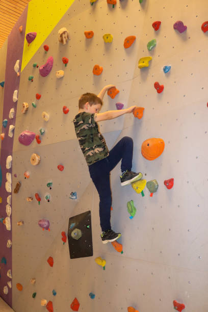 istock Young boy climbing on bouldering wall 1302053672
