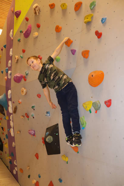 istock Young boy climbing on bouldering wall 1302053694
