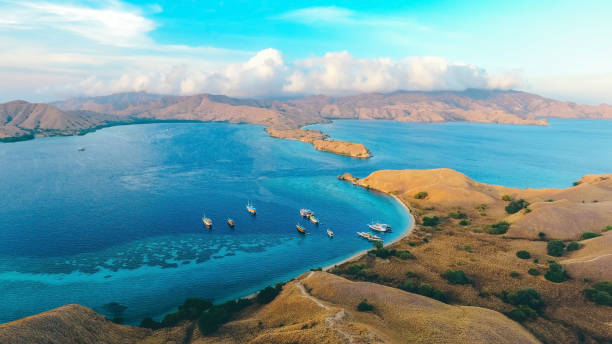 Aerial iew of Gili Laba or Lawa Darat located in Komodo National Park Aerial iew of Gili Laba or Lawa Darat located in Komodo National Park, Labuan Bajo, Indonesia. Strong current can be seen entering into the channel pulau komodo stock pictures, royalty-free photos & images