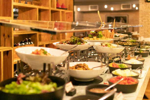 istock Assorted fresh salads displayed on a buffet in individual containers at restaurant. 1302057619