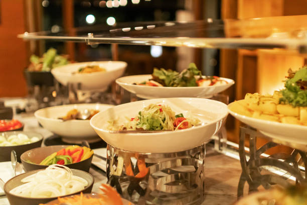 istock Assorted fresh salads displayed on a buffet in individual containers at restaurant. 1302058123