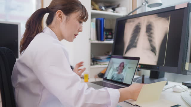 Female doctor talking with her patient remotely via telemedicine from her medical office.