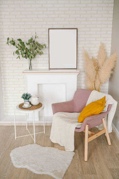 istock Breakfast still life scene. Coffee cup teapot white table, empty picture frame mockup, cozy stylish armchair blanket. Elegant working space, home office concept. Scandinavian interior room design. 1302064373