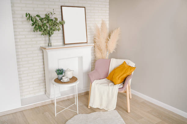 istock Breakfast still life scene. Coffee cup teapot white table, empty picture frame mockup, cozy stylish armchair blanket. Elegant working space, home office concept. Scandinavian interior room design. 1302064392