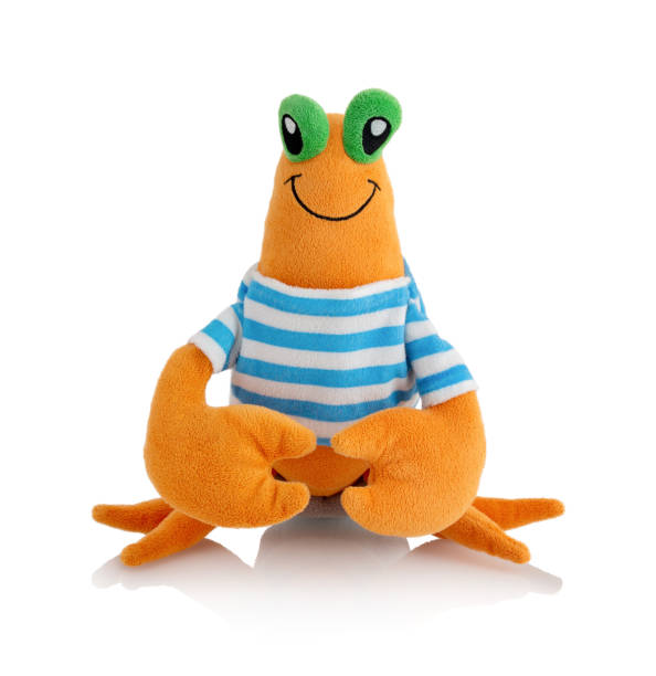 Strawberry land hermit crab plushie doll isolated on white background with shadow reflection. Plush stuffed puppet on white backdrop. Fluffy crab toy for children. Cute furry animal plaything for kids