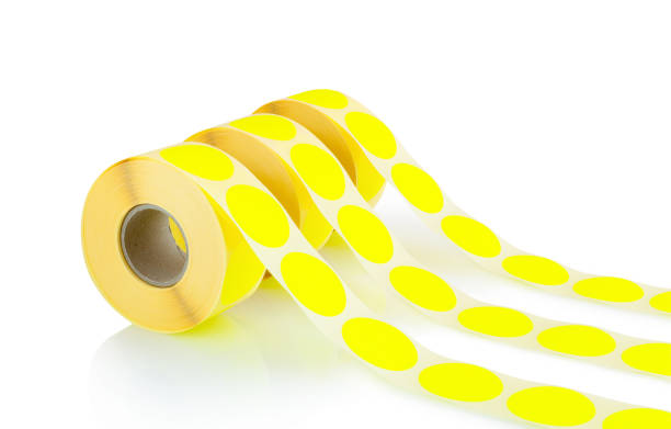 istock Yellow label rolls isolated on white background with shadow reflection. Reels of colored labels for printer. Labels for direct thermal or thermal transfer printing. 1302064470