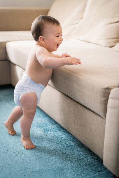 istock Excited smiling happy Baby boy learning to walk 1302065542