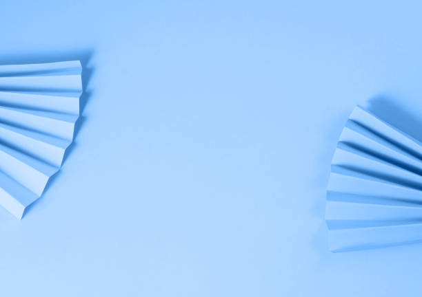 istock Pastel color paper fans on blue background 1302065694