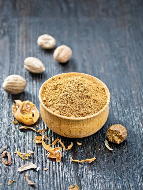 istock Nutmeg round in bowl on black board 1302066278