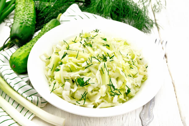 istock Salad of cabbage with cucumber in plate on board 1302066727