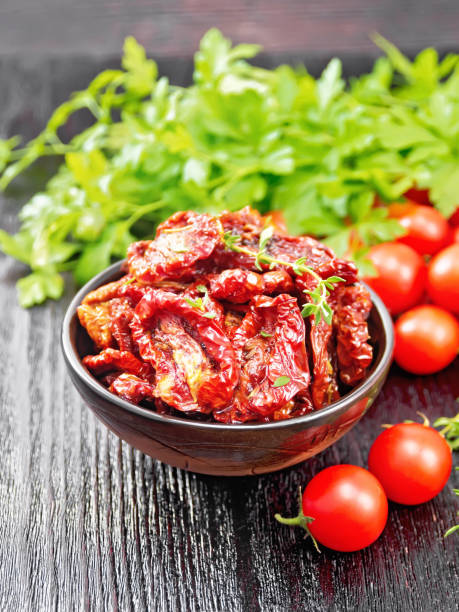 istock Tomatoes sun-dried in bowl on black board 1302067330