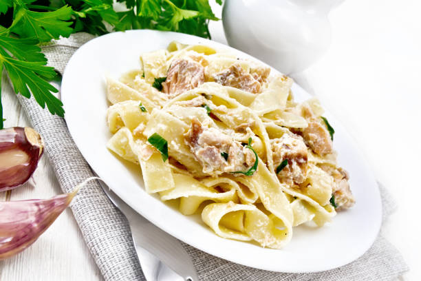 istock Pasta with salmon and cream on light board 1302067657