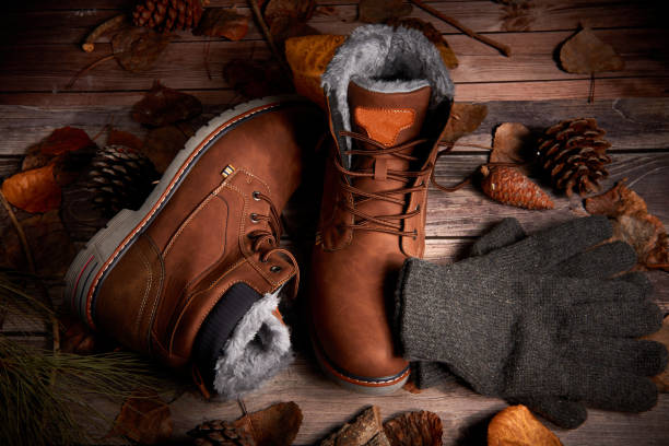istock A pair of brown boots on a wooden table 1302067739