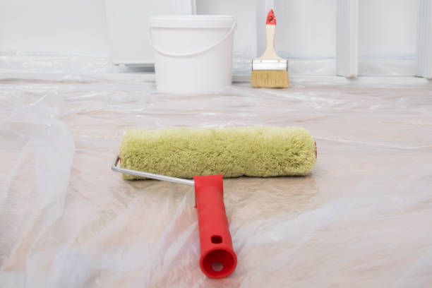 istock indoor renovation concept: the wall paint roller lies on the floor covered with polyethylene, preparation for finishing work 1302070106