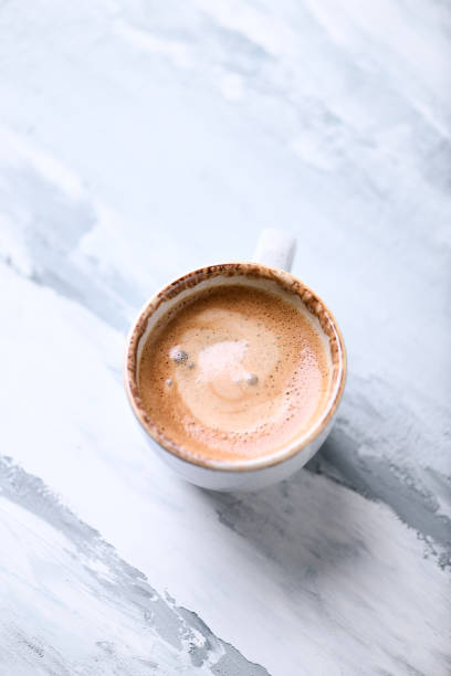 istock Cup of coffee on bright wooden background. Close up. 1302071957