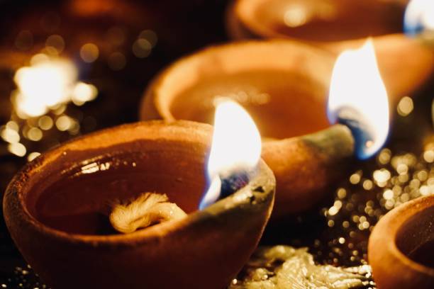 istock Festive Oil Lamp burning and emitting light in the night darkness. 1302074285