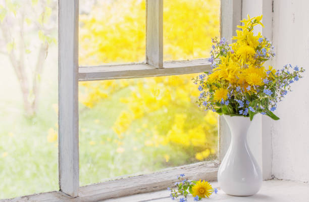 istock dandelions and forget-me-not in vase on windowsill 1302076216