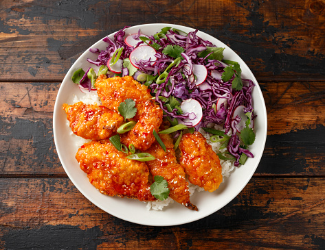 Korean Fried chicken with red cabbage salad and white rice. Asian food.