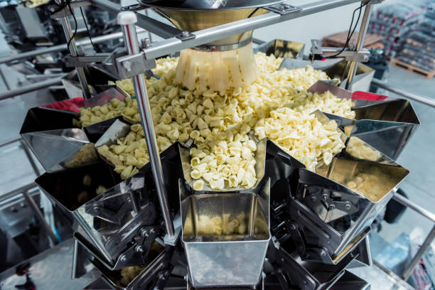 istock Vertical multi-head weigher packaging machine snacks and chips in a factory 1302077261