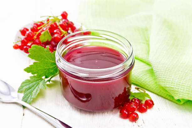 istock Jam of red currant in jar on board 1302077303