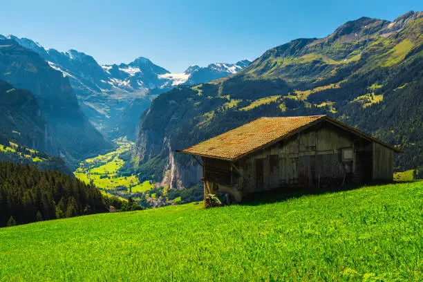Photo of Wooden hut on the green field with Lauterbrunnen valley view