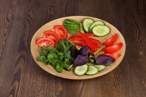 istock Tomatoes, cucumbers and greens on a glass plate 1302079170