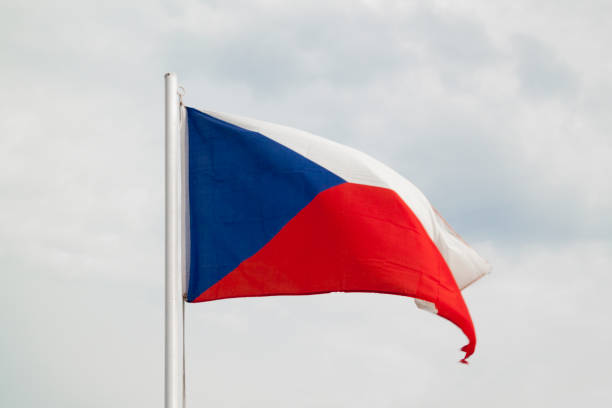 istock Czech Republic flag on a blue sky with clouds background 1302080255