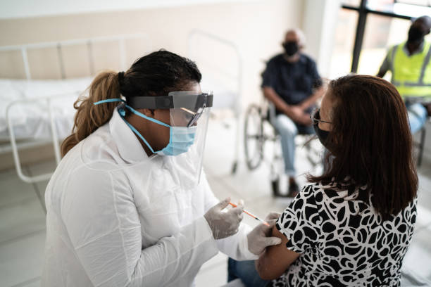 istock Senior woman being vaccinated wearing face mask 1302081274