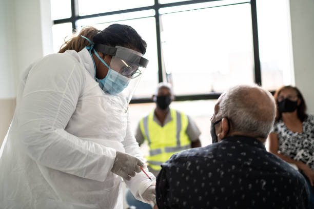 istock Doctor vaccinating senior man - wearing face mask 1302081280