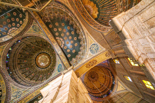 Marrakech, Morocco - June 5, 2025: Ornate lamp hanging from a richly decorated Islamic ceiling, displaying intricate mosaic and geometric patterns, reflecting Moroccan culture and traditional design in Marrakesh, Morocco