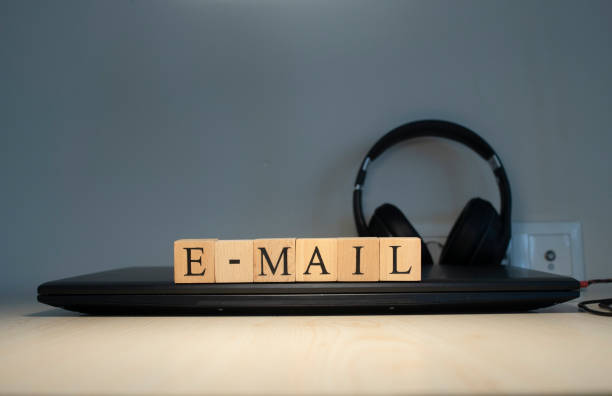 istock email word written on the background computer and headset concept. Closeup. 1302082293