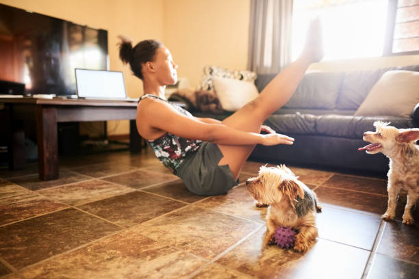 istock Pets looking at woman doing yoga 1302082484