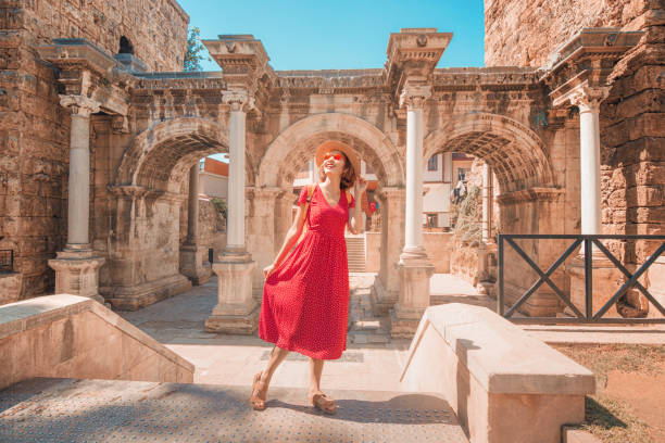 happy female tourist traveler discover interesting places and popular attractions and walks in the old city of antalya, turkey. the famous roman gate of hadrian - turkey tourist ephesus roman imagens e fotografias de stock