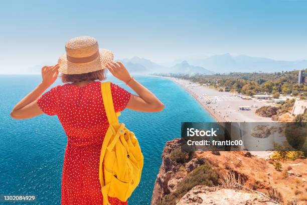 Happy Female Tourist Looking From The Height Of The Observation Viewpoint Overlooking Konyaalti Beach In Antalya Tourism And Lifestyle In Turkey Stock Photo - Download Image Now