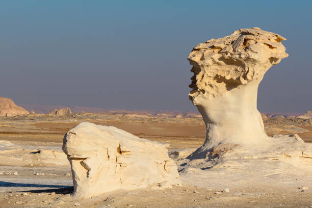 Bizarre sandstone formations in the white desert, early morning Bizarre limestone formations in the Lybian desert, white desert near Farafra, Egypt egypt horizon over land sun shadow stock pictures, royalty-free photos & images