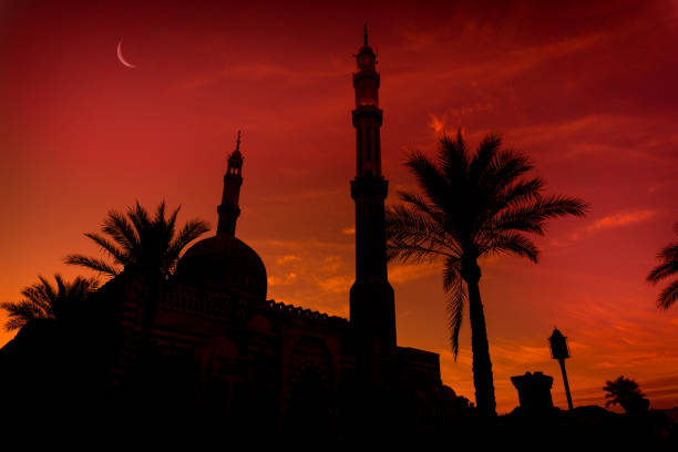 istock Beautiful large Islamic mosque at the sunset sky background 1302085500