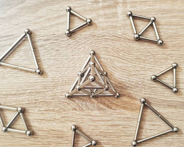 istock Pyramid made from magnet top point of view on wood background 1302085893