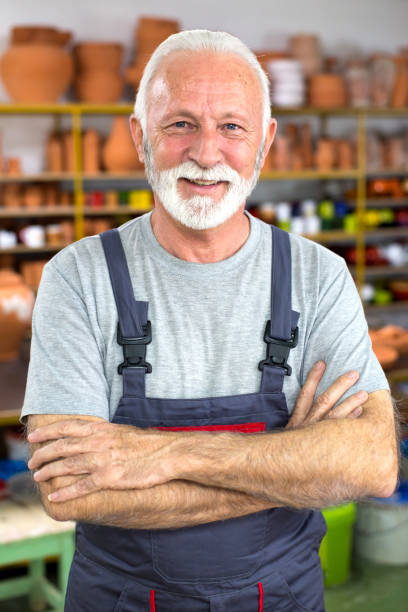 istock Senior craftsperson in his pottery workshop 1302087733