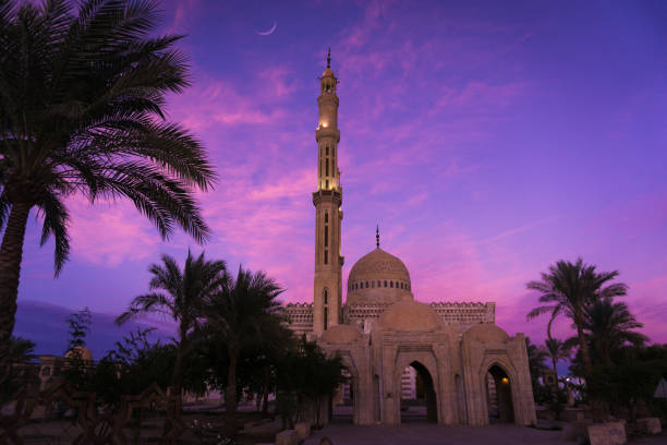 istock Beautiful large Islamic mosque at the sunset sky background 1302087777