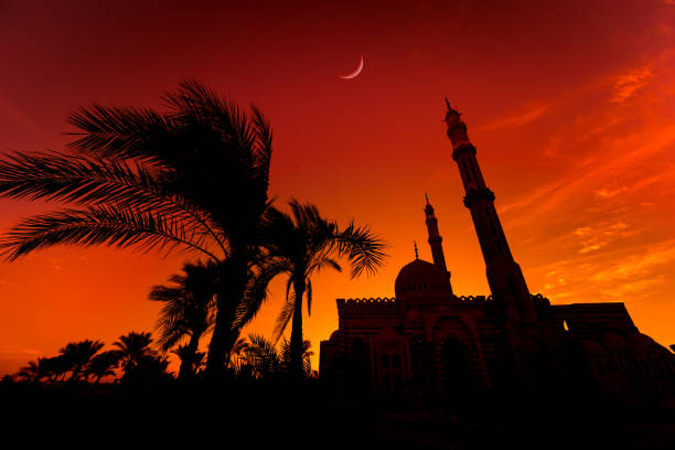 istock Beautiful large Islamic mosque at the sunset sky background 1302087806