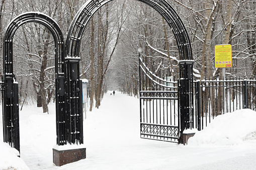 Moscow, Russia. 13th February 2021. A blizzard covered the city. Entrance gate of Terletskiy park in Moscow